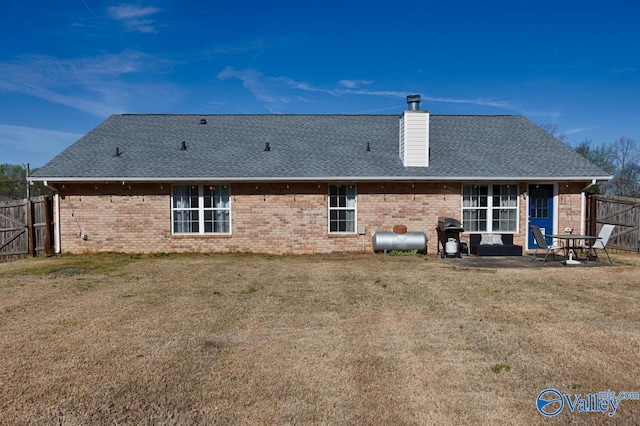 107 Harvest Glen Ln, Harvest, AL 35749 - rear view of property featuring a chimney, a fenced backyard, brick siding, roof with shingles, and a patio area
