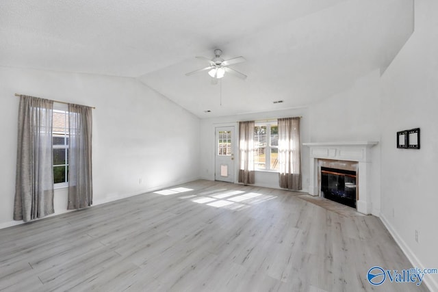 107 Harvest Glen Ln, Harvest, AL 35749 - unfurnished living room with a fireplace, lofted ceiling, a ceiling fan, and wood finished floors
