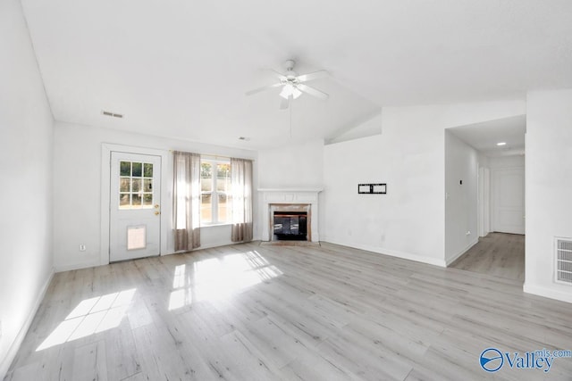 107 Harvest Glen Ln, Harvest, AL 35749 - unfurnished living room featuring a ceiling fan, lofted ceiling, light wood finished floors, a tiled fireplace, and visible vents