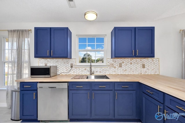 107 Harvest Glen Ln, Harvest, AL 35749 - kitchen with a sink, blue cabinets, visible vents, backsplash, and appliances with stainless steel finishes