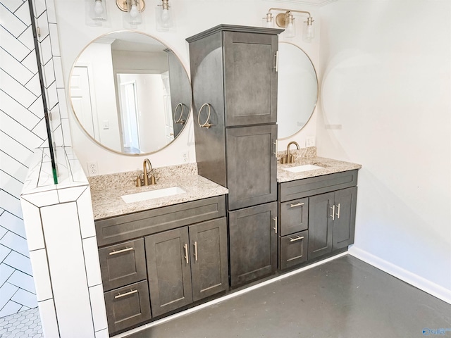 bathroom featuring finished concrete flooring, baseboards, and vanity