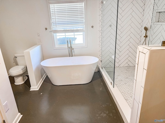 bathroom featuring washer / clothes dryer, toilet, finished concrete floors, a freestanding tub, and walk in shower