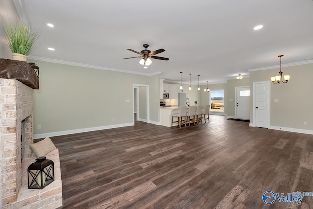 unfurnished living room with crown molding, dark wood-type flooring, and a fireplace