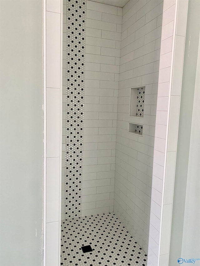 bathroom with tiled shower