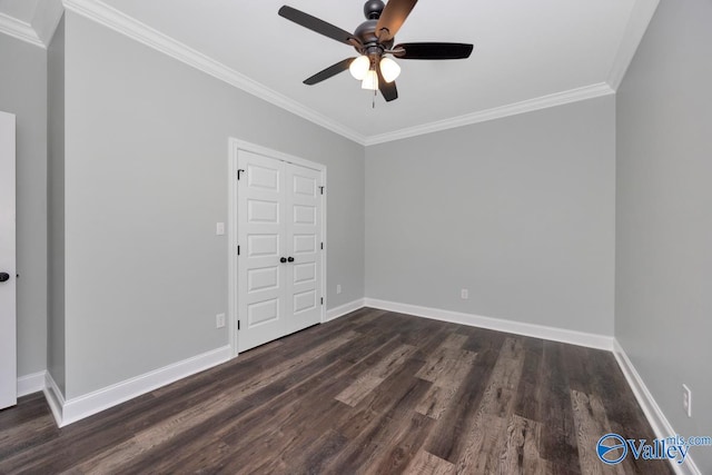 unfurnished bedroom with dark hardwood / wood-style flooring, ornamental molding, and ceiling fan