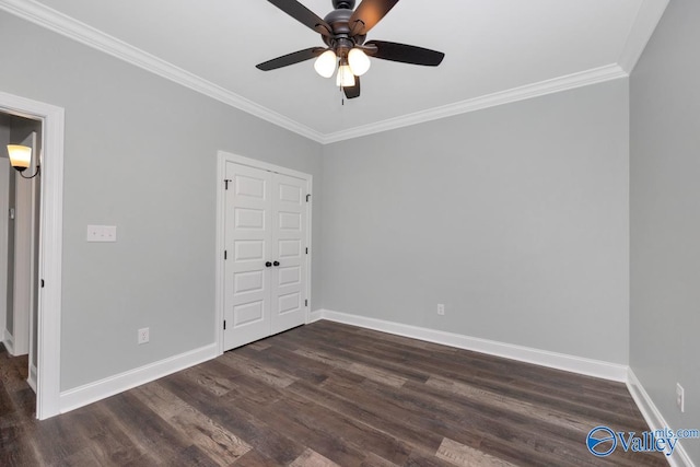 unfurnished bedroom featuring crown molding, a closet, dark wood-type flooring, and ceiling fan