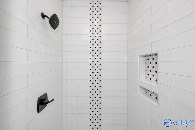 bathroom with tiled shower