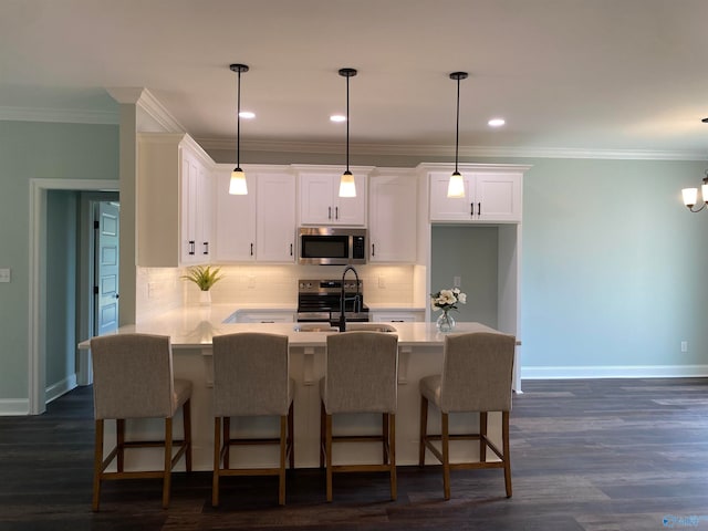 kitchen featuring pendant lighting, white cabinetry, stainless steel appliances, and dark hardwood / wood-style floors