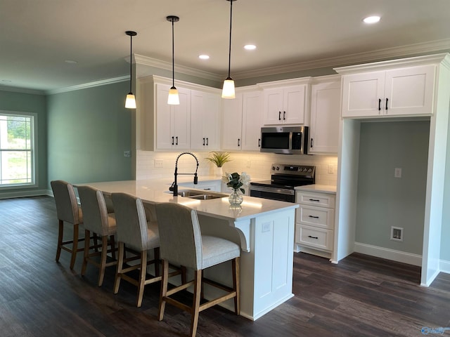 kitchen with sink, kitchen peninsula, hanging light fixtures, white cabinetry, and stainless steel appliances