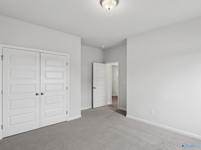 unfurnished bedroom featuring carpet floors and a closet