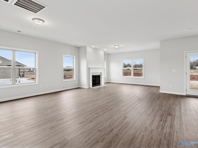 unfurnished living room with wood-type flooring