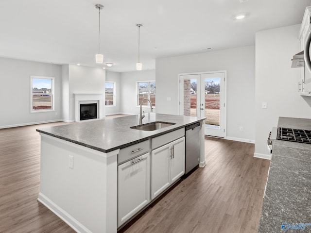 kitchen with white cabinets, dishwasher, sink, and hanging light fixtures