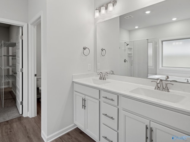 full bathroom featuring hardwood / wood-style flooring, toilet, vanity, and shower with separate bathtub