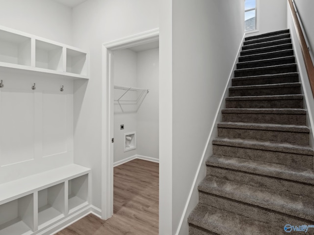 stairs featuring hardwood / wood-style flooring