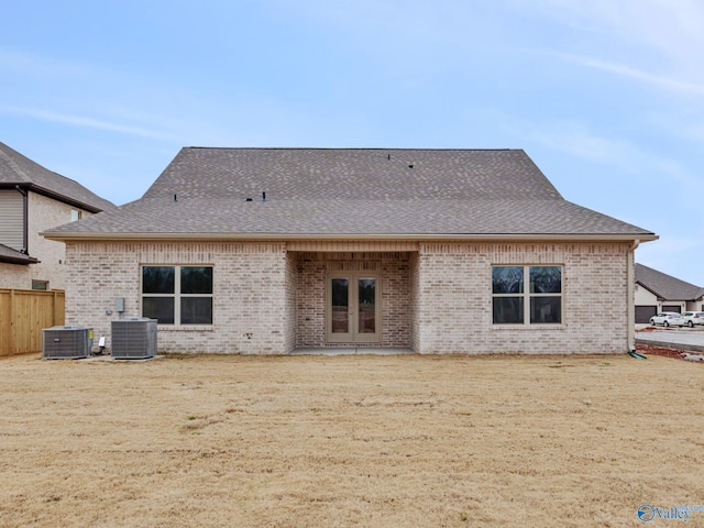 back of property with french doors and central AC