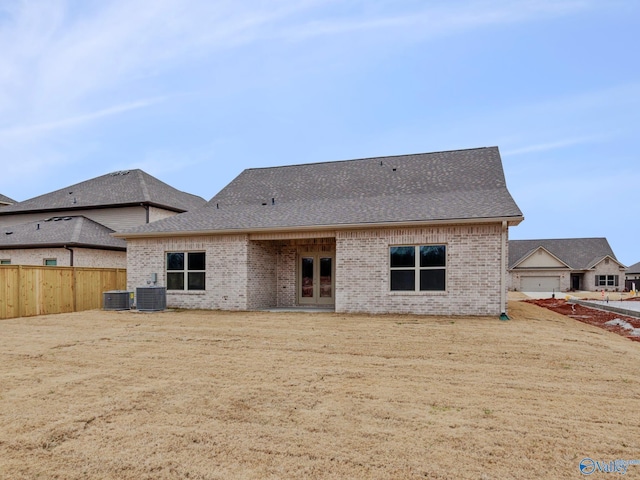 rear view of house with central air condition unit and french doors