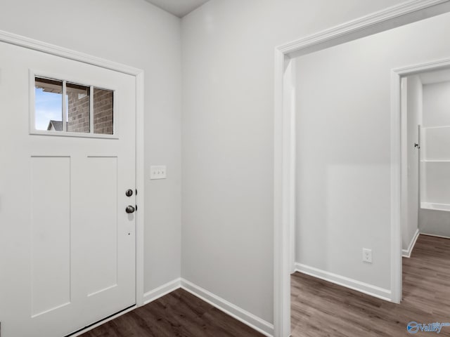 entryway with dark hardwood / wood-style flooring