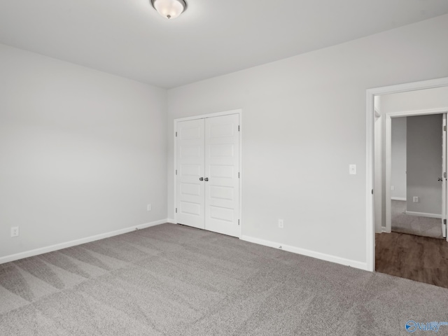 unfurnished bedroom featuring carpet and a closet