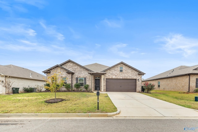 view of front of home with a front lawn and a garage