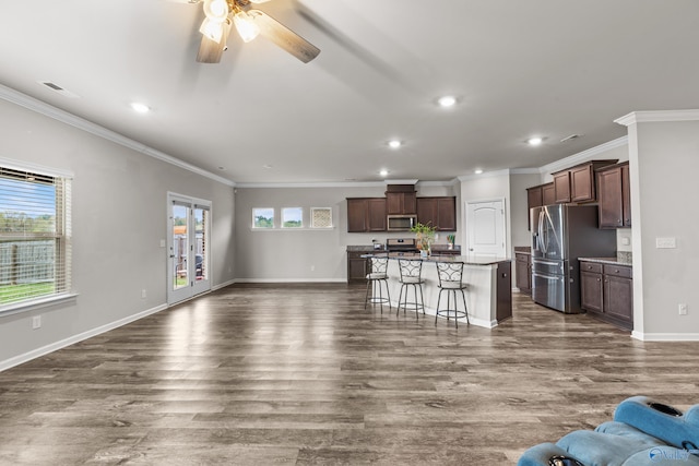 unfurnished living room featuring dark hardwood / wood-style floors, ceiling fan, and crown molding