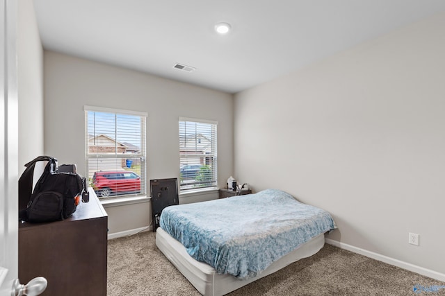 bedroom featuring light carpet