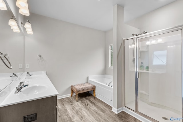 bathroom with vanity, wood-type flooring, and shower with separate bathtub