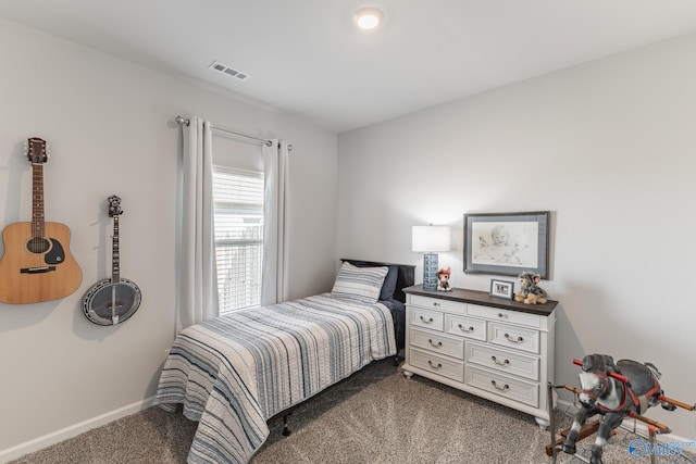 bedroom with baseboards, visible vents, and carpet
