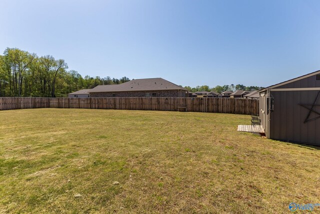 view of yard with an outdoor structure and a fenced backyard