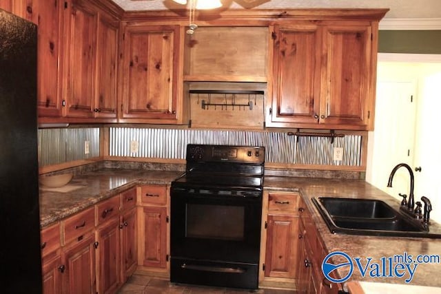 kitchen with ornamental molding, light stone counters, black range with electric stovetop, and sink