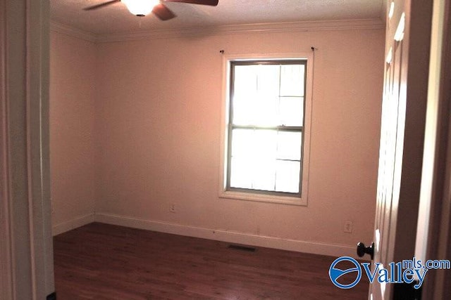 empty room with ceiling fan, ornamental molding, and dark hardwood / wood-style flooring