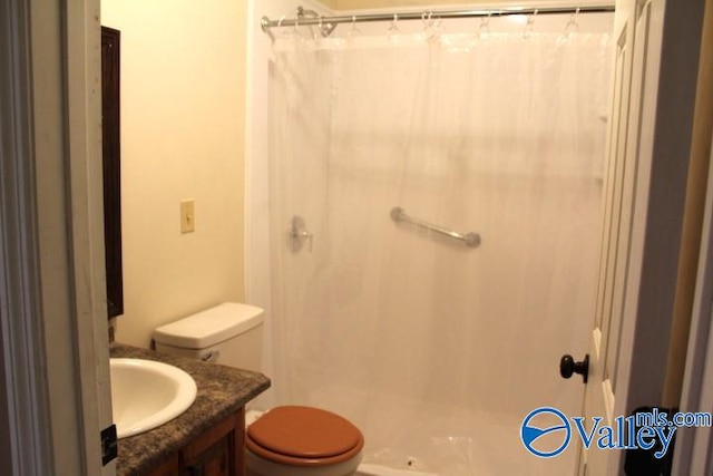 bathroom with walk in shower, vanity, and toilet