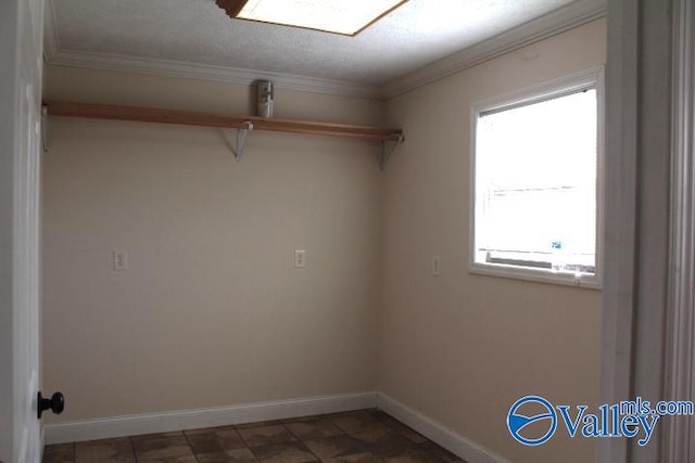 interior space with a textured ceiling, plenty of natural light, and crown molding