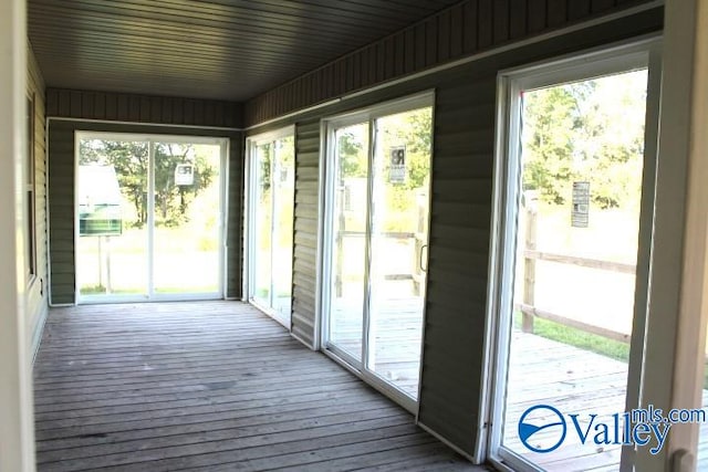 unfurnished sunroom featuring a wealth of natural light