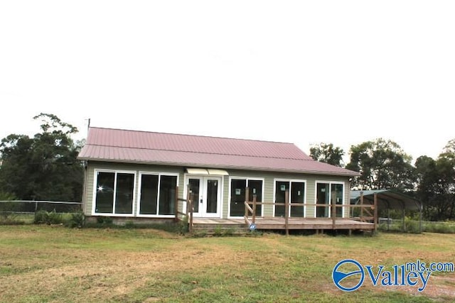 back of property featuring a lawn and a carport