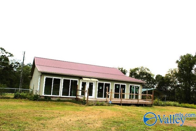 rear view of property with a lawn