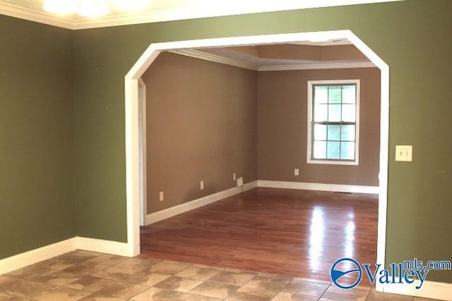 empty room featuring hardwood / wood-style flooring and crown molding