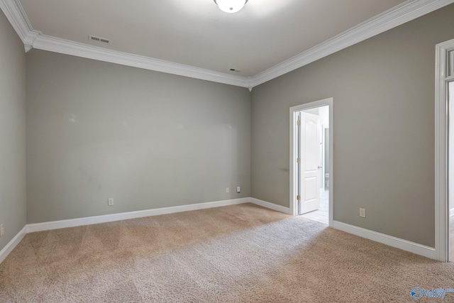 unfurnished room featuring light carpet, baseboards, visible vents, and crown molding