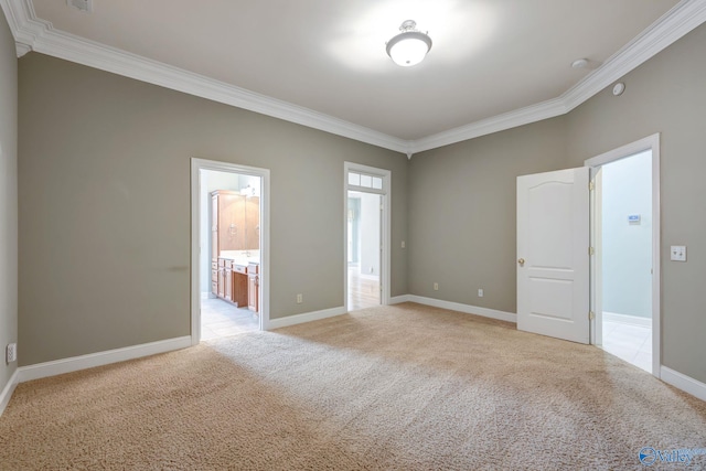 unfurnished room featuring baseboards, crown molding, and light colored carpet