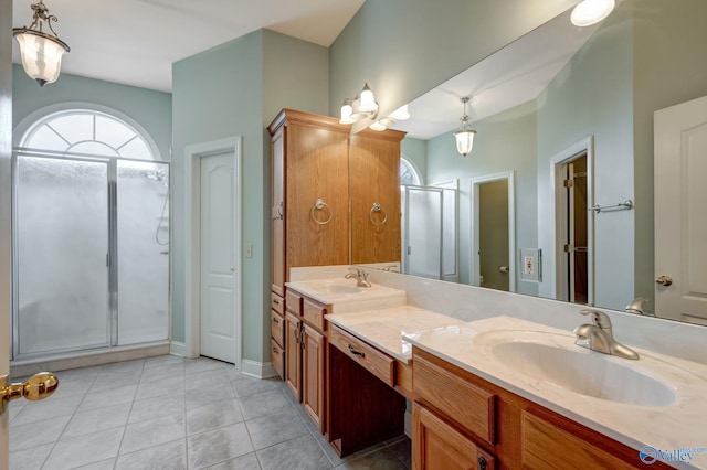 full bathroom with double vanity, a sink, a shower stall, and tile patterned floors