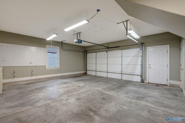 garage with a garage door opener and baseboards