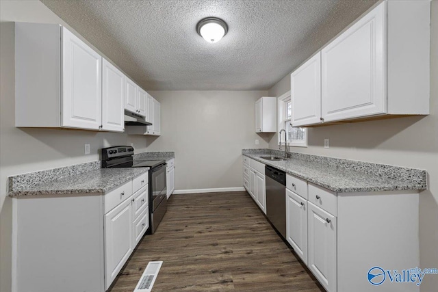 kitchen featuring sink, white cabinetry, stainless steel appliances, light stone counters, and dark hardwood / wood-style flooring