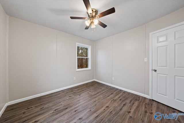 unfurnished room featuring dark wood-type flooring and ceiling fan