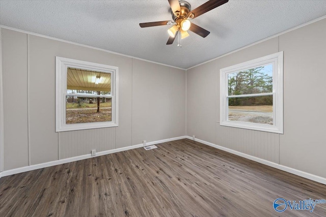 spare room featuring hardwood / wood-style flooring, ornamental molding, ceiling fan, and a textured ceiling