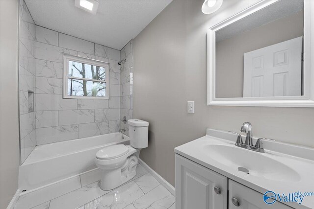 full bathroom featuring vanity, a textured ceiling, toilet, and tiled shower / bath