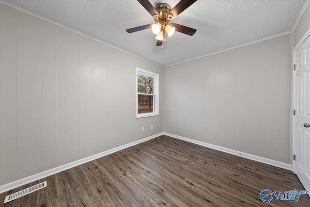 spare room with crown molding, ceiling fan, dark hardwood / wood-style flooring, and a textured ceiling