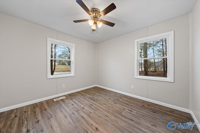 empty room with hardwood / wood-style flooring and ceiling fan