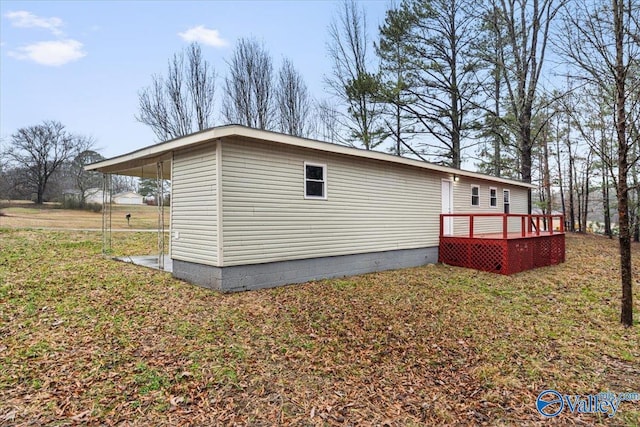 view of home's exterior featuring a yard and a deck