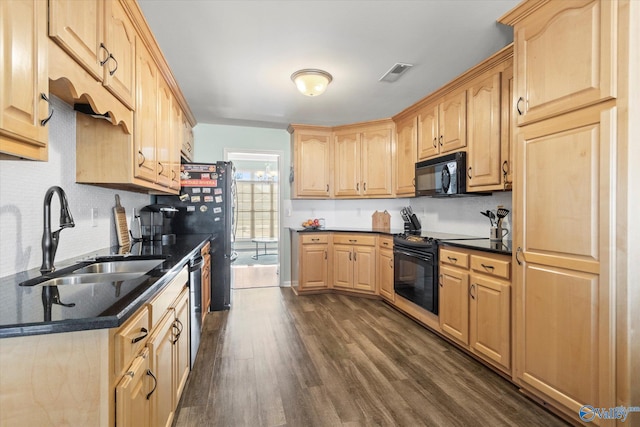 kitchen featuring light brown cabinetry, sink, and black appliances