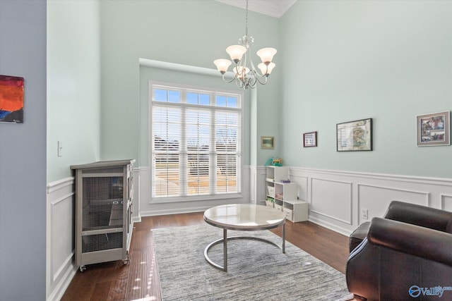 sitting room with dark hardwood / wood-style flooring and a chandelier