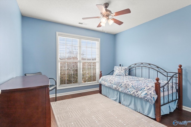 bedroom with ceiling fan and wood-type flooring